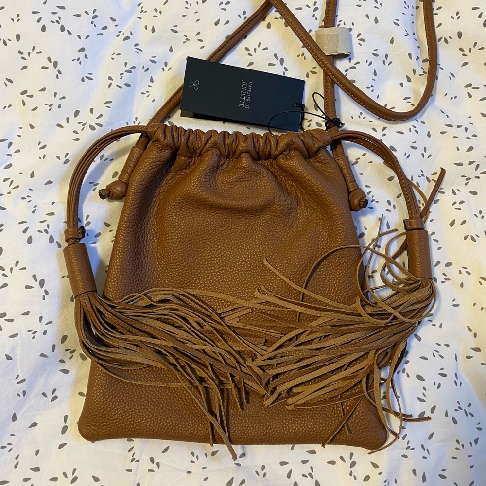 Brown leather drawstring bag.
